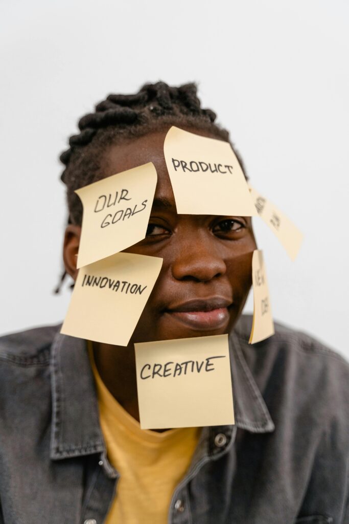 African American man with motivational sticky notes on his face. Creative idea concept.